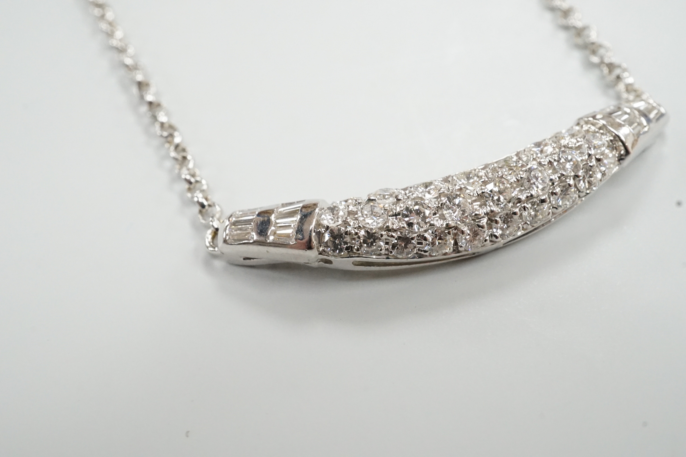 A modern Italian 750 white metal, trapeze and round cut diamond set cluster pendant necklace, 44cm, gross weight 8.8 grams.